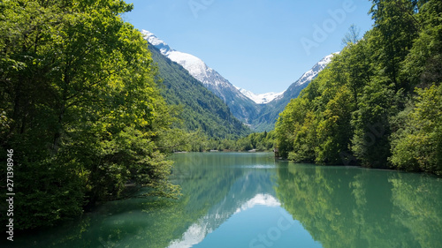 Austrian lake with reflection of snowy mountain behind
