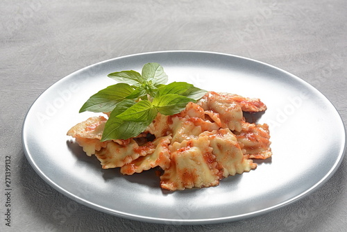 Ravioli with tomato sauce and basil, italian cuisine