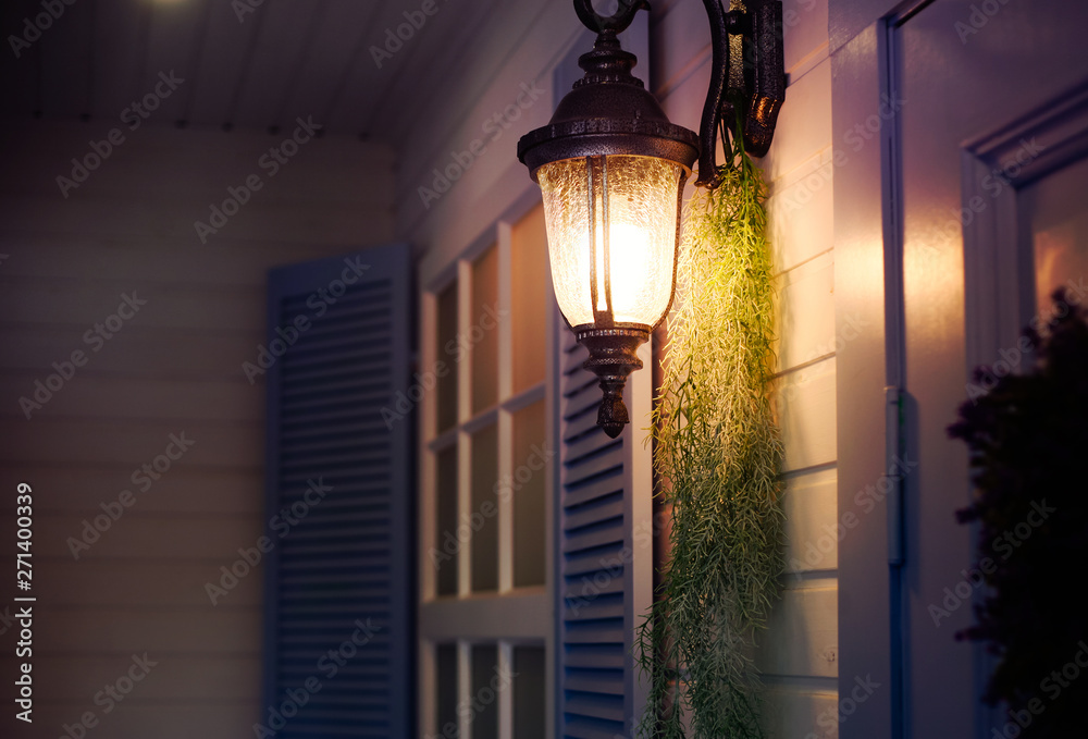 Vintage iron lantern on the wall outdoor. Exterior design elements.