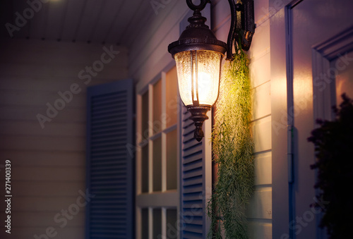 Vintage iron lantern on the wall outdoor. Exterior design elements.