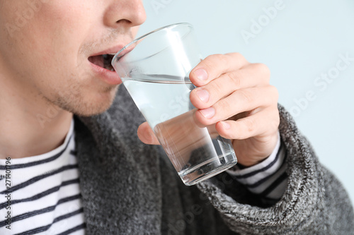 Handsome young man drinking...