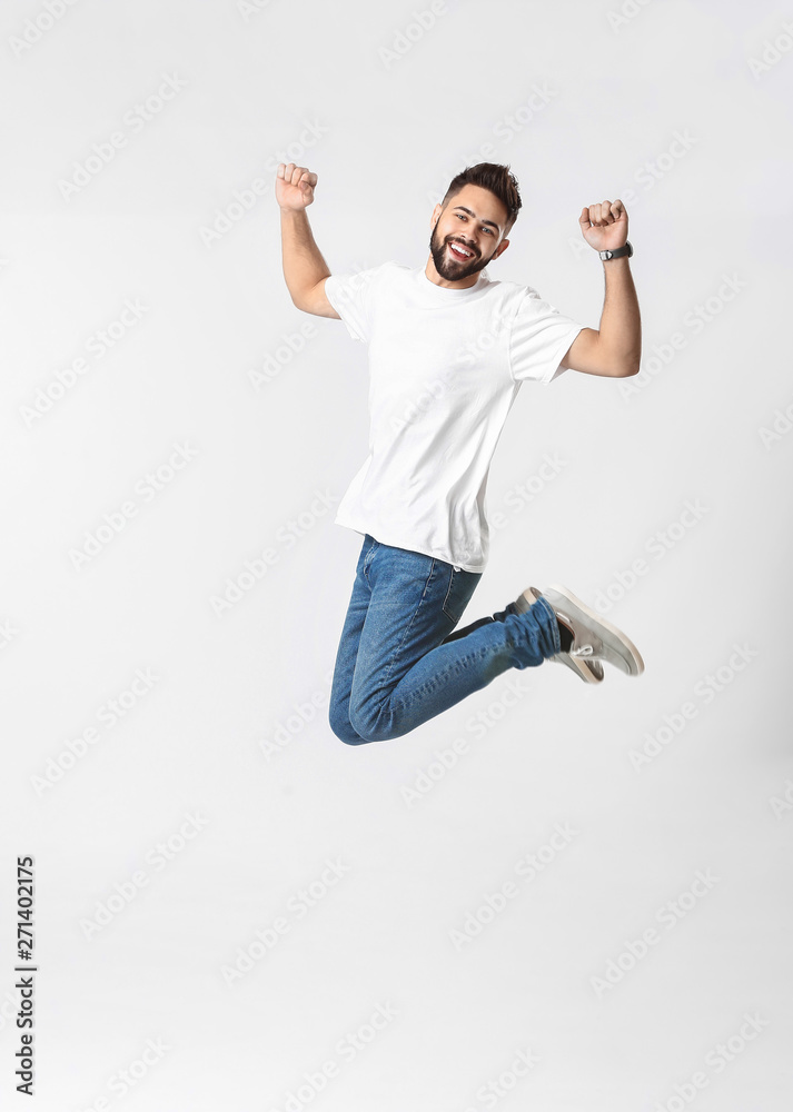 Jumping young man in jeans on white background Jumping young man in jeans on white background