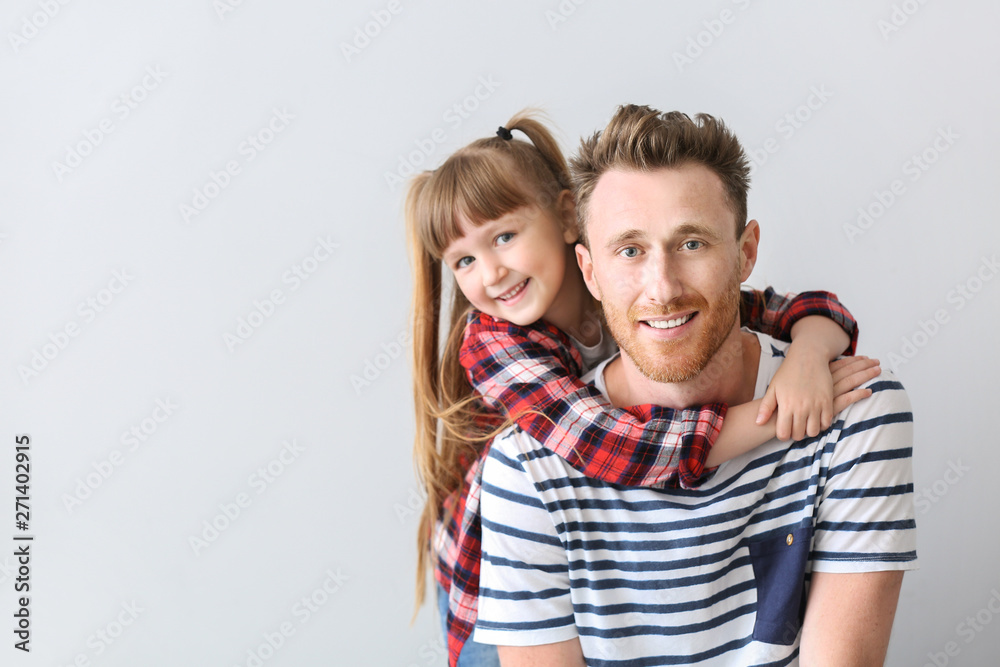 Portrait of happy father and daughter on light background Portrait of happy father and daughter on light background
