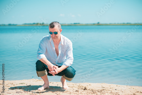 Mature European man with a good mood, outdoor portrait. The concept of life after 50 years 