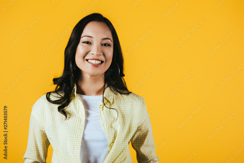 smiling brunette asian girl isolated on yellow smiling brunette asian girl isolated on yellow