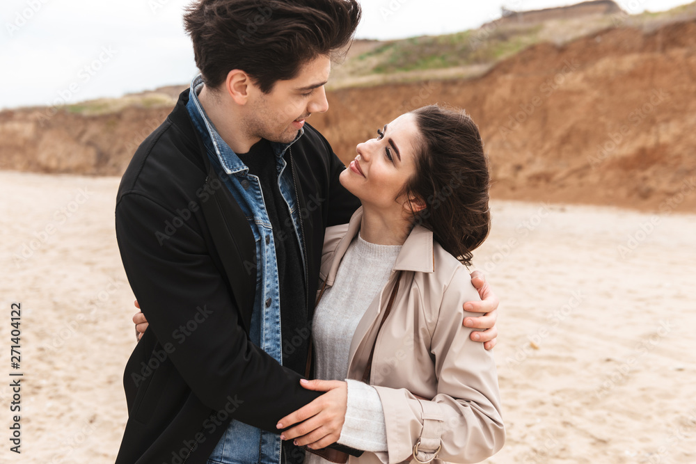 Happy young couple wearing autumn coats Happy young couple wearing autumn coats