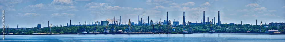 Panorama of the port and the factory industrial area with many pipes with smoke