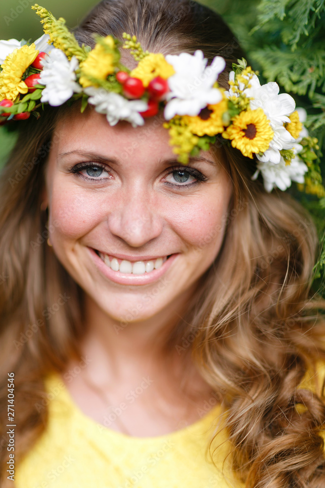 Portrait young girl in yellow dress with Flower wreath for head. Walking in park, Warm summer day. Portrait young girl in yellow dress with Flower wreath for head. Walking in park, Warm summer day.