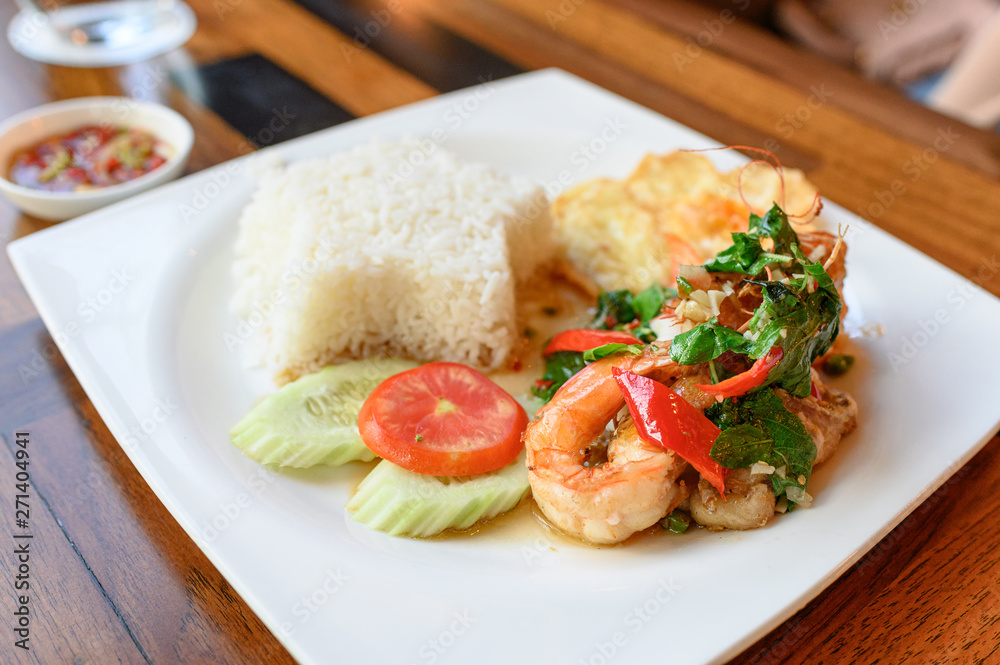 Stir-fried basil, chili with shrimp, squid with fried egg and white rice Stir-fried basil, chili with shrimp, squid with fried egg and white rice