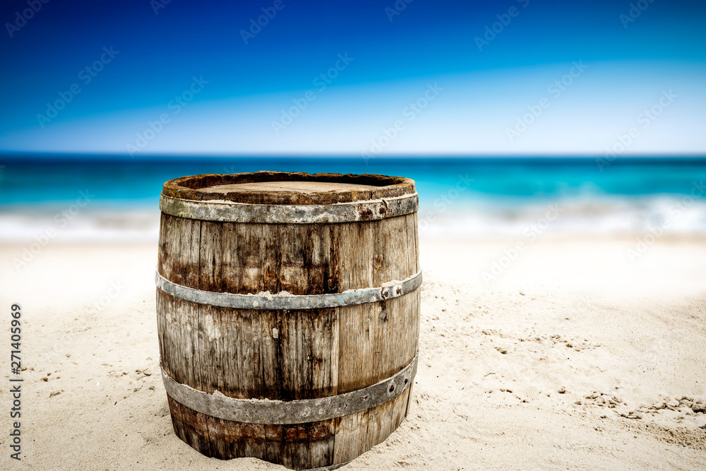 Naklejka premium Wooden barrel on beach and free space for your decoration. 