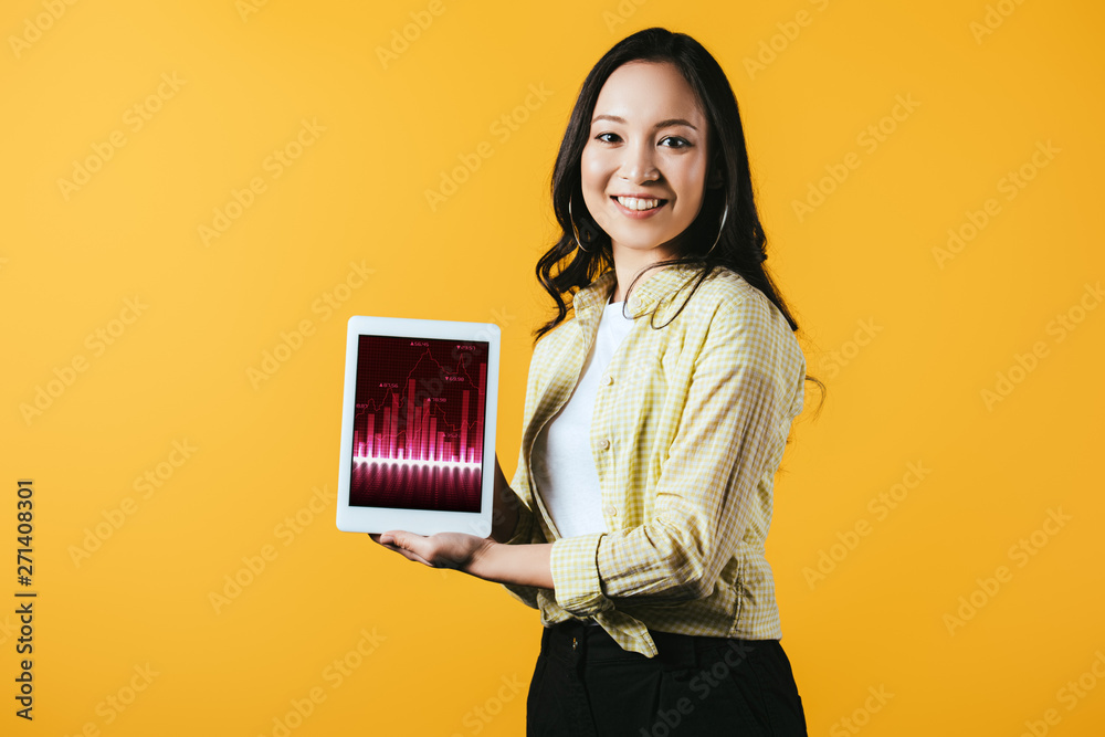 happy asian girl showing digital tablet with graph, isolated on yellow happy asian girl showing digital tablet with graph, isolated on yellow
