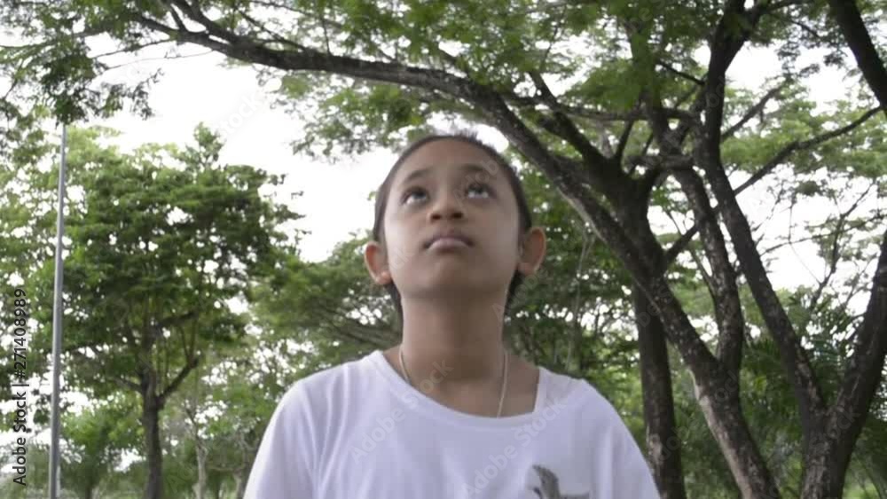 Young cute girl walking on the pathway in public park, Slow motion.