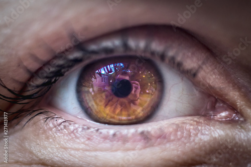 Macro eye photo with purple orange cornea