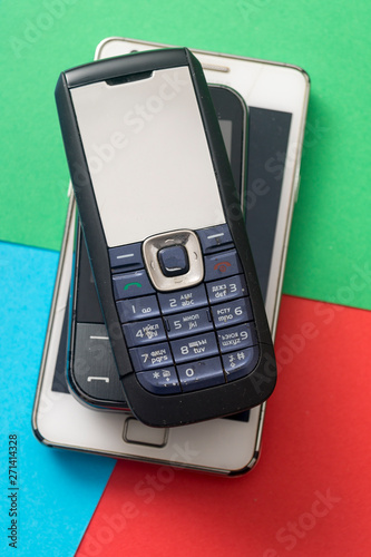 Old and obsolete cellphone on a RGB background.
