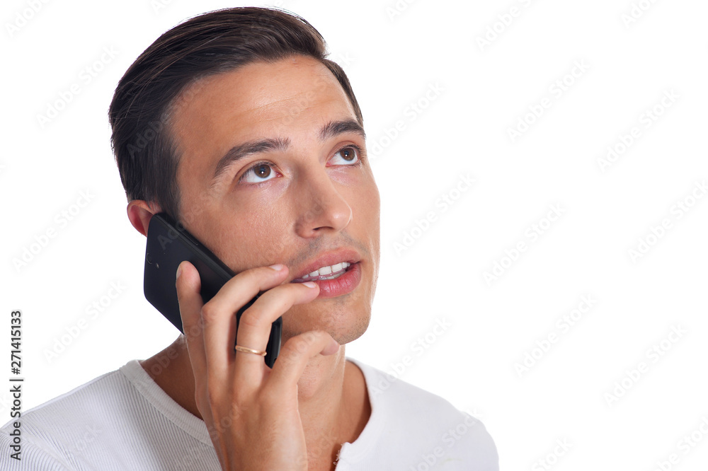 Handsome young man in white clothing talking on smartphone posing on white background Handsome young man in white clothing talking on smartphone posing on white background