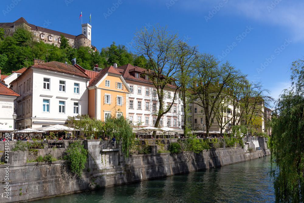 Ljubljana, Slovenia. River bank, tenements and castle on the hill