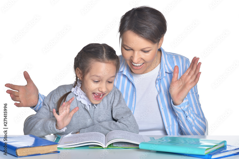 Mother with daughter doing homework on white background Mother with daughter doing homework on white background