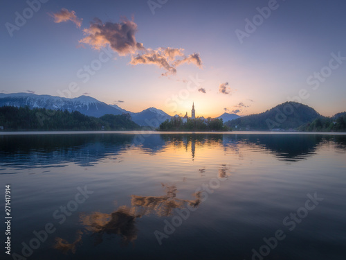 Sunrise at Lake Bled and Assumption of Mary church on the island in center of the lake