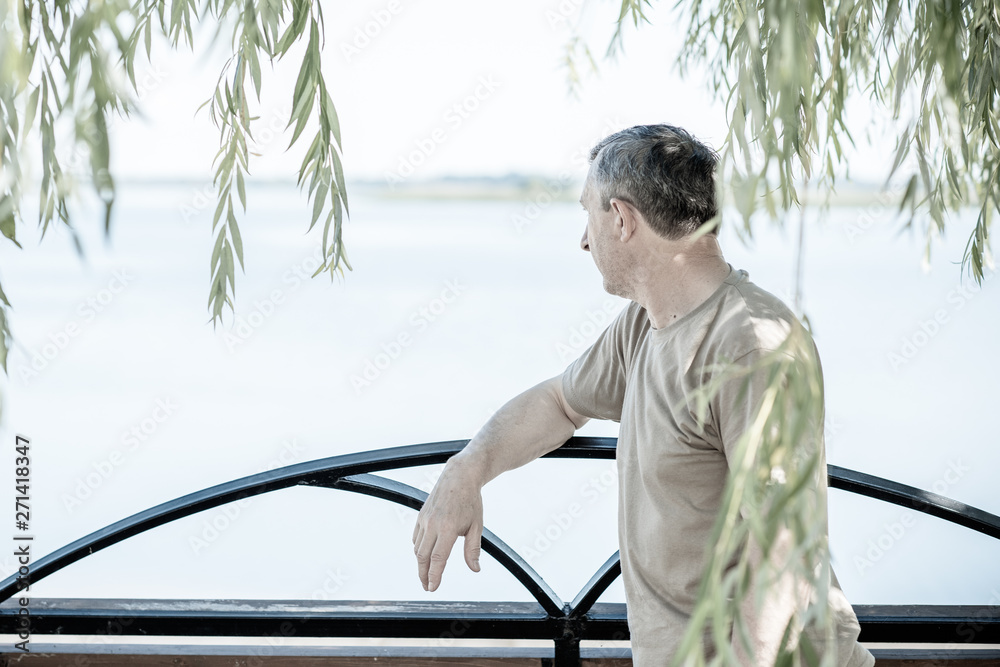 Fototapeta premium Mature European man with a sad philosophical mood. The concept of life after 50 years, problems and depression. Crisis of middle age