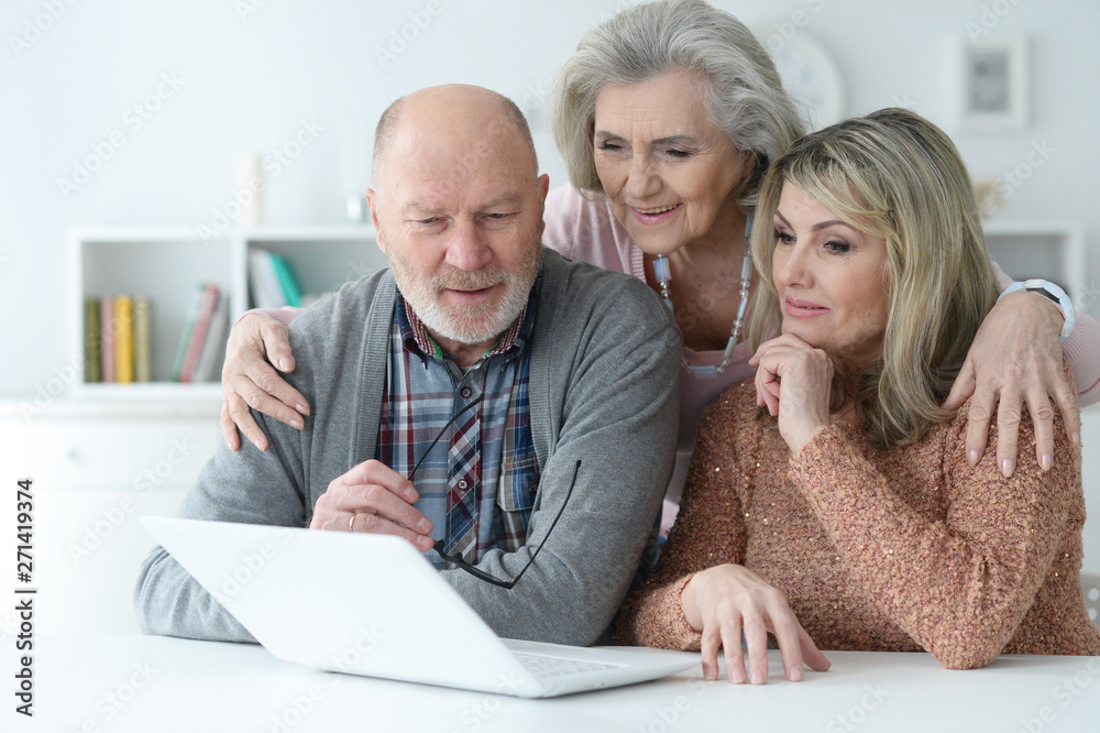 Portrait of two senior women and man using laptop Portrait of two senior women and man using laptop