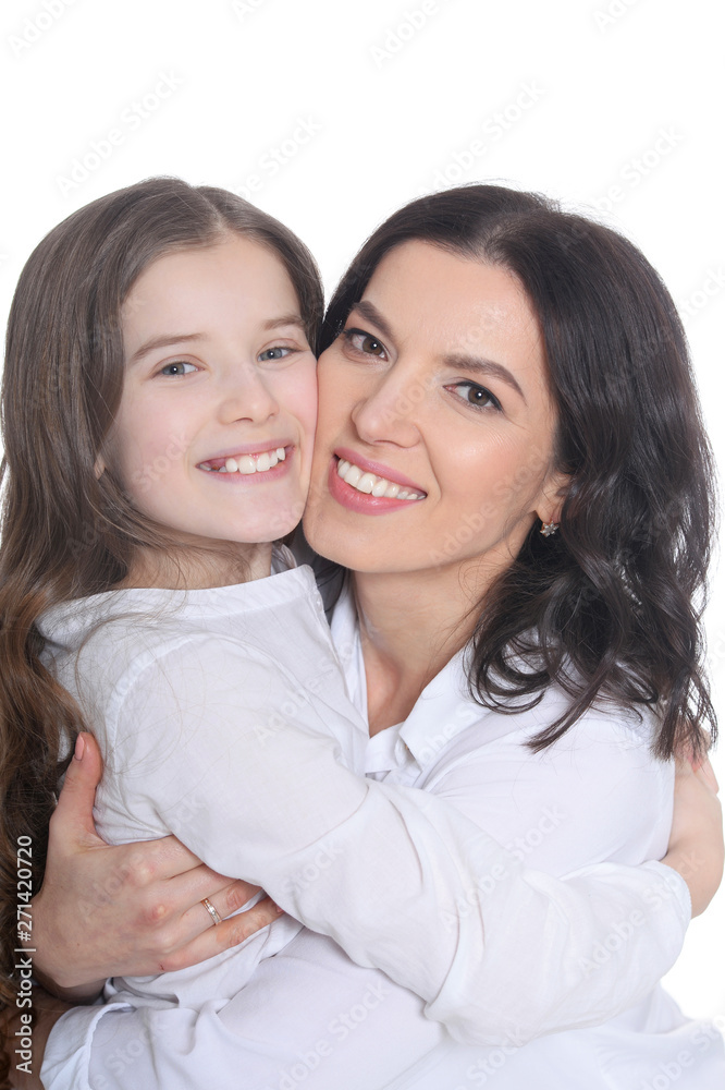 Portrait of happy mother and daughter posing on white background