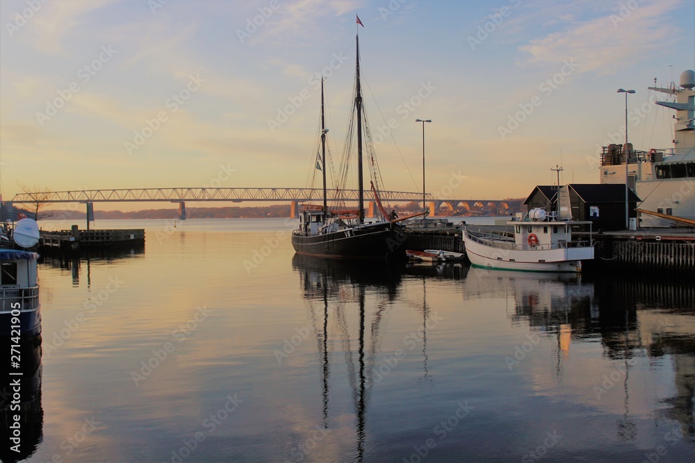 boats in harbor at sunset