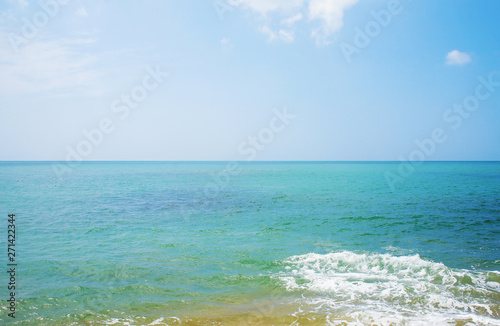 Southern tropical summer ocean coast with rocks and rocks. Lagoon with a yellow sandy beach and azure water.