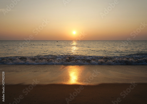 Southern tropical summer ocean coast at sunset. Lagoon with waves in which the sun is reflected. © Payllik