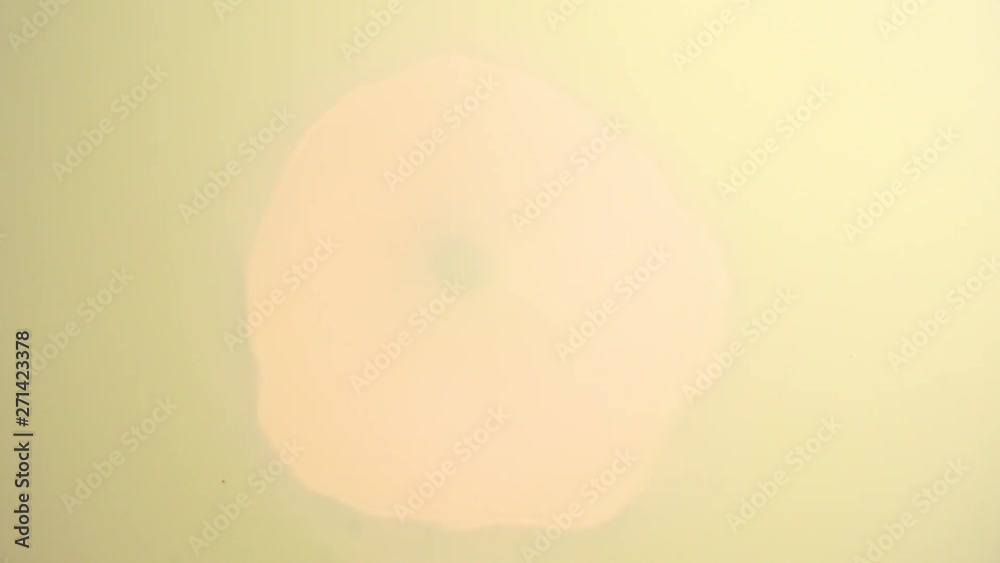 Abstract golden background with light in center and particles. Starburst with sparks, seamless loop texture. Abstract golden background with light in center and particles. Starburst with sparks, seamless loop texture.