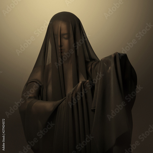 Girl in a black transparent veil on the face. Conceptual portrait in the studio. Minimalism.