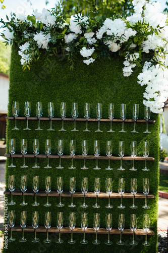 A lot of glasses of champagne in a green atmosphere.  Secular reception, new year, wedding