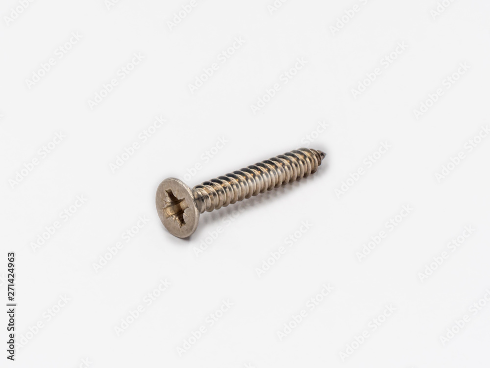 Cross recessed inox tapping screw, flat head shot on white. Cross recessed inox tapping screw, flat head shot on white.