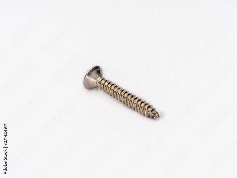 Cross recessed inox tapping screw, flat head shot on white. Cross recessed inox tapping screw, flat head shot on white.