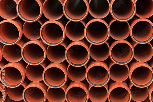 Orange sewer pipes. Background from plastic pipes.