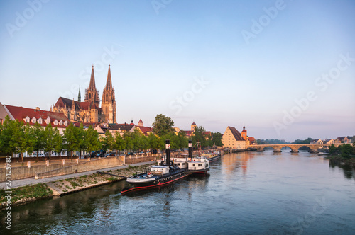 Regensburg cityscape with Danube river embankment St. Peters Cathedral and Stone Bridge Bavaria Germany