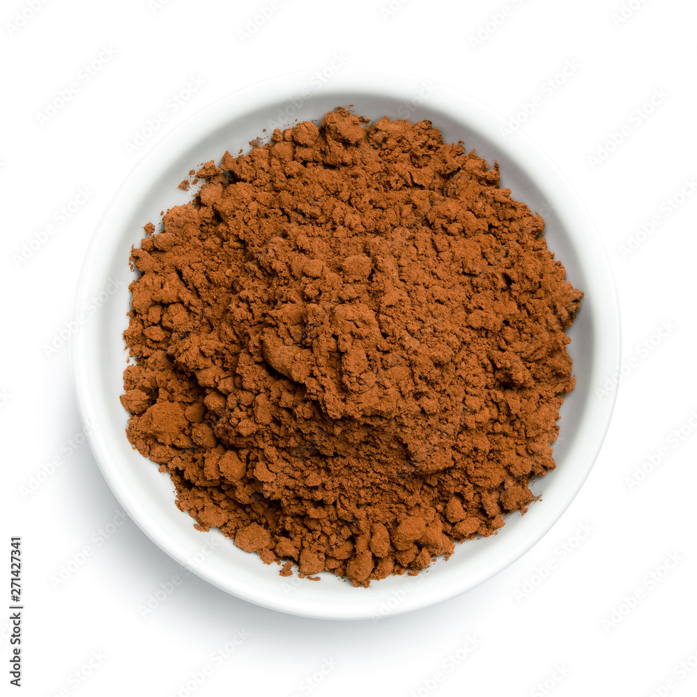 Cocoa powder in a white ceramic bowl isolated on white from above. Cocoa powder in a white ceramic bowl isolated on white from above.