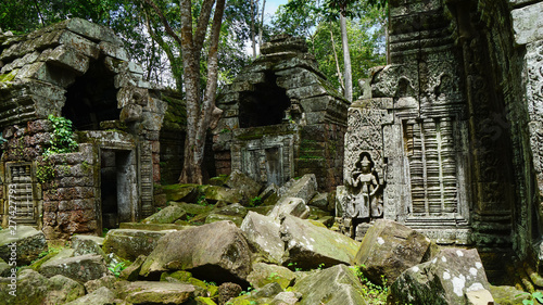 Ruined architectural heritage of Ta Phrom ancient temple complex with old scattered stones and rock. (Angkor Wat, UNESCO World Heritage Site, Siem Reap, Cambodia)