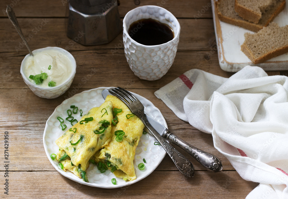 Homemade breakfast of omelet with asparagus and onions and hot coffee. Rustic style. Homemade breakfast of omelet with asparagus and onions and hot coffee. Rustic style.