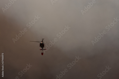 helicopter in flight fighting fires in california