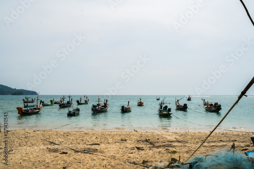 Fishing boats in the sea parked near the beach Near the international airport in Phuket  Thailand.