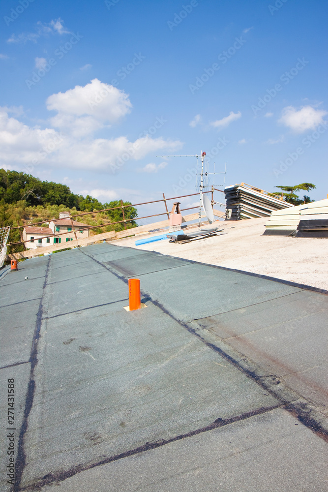 Italian construction site with roof covered with thermal insulation and polystyrene panels with waterproof membrane