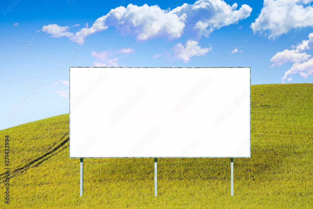 A blank advertising billboard immersed in a grass field A blank advertising billboard immersed in a grass field
