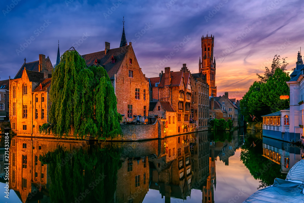 Classic view of the historic city center with canal in Brugge, West Flanders province, Belgium. Night cityscape of Brugge.