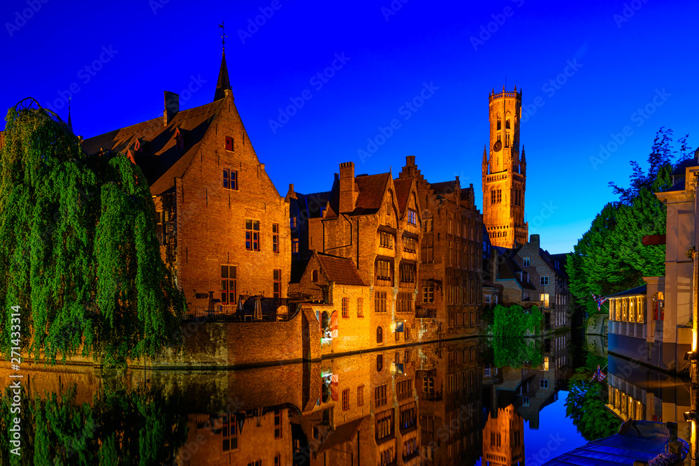 Classic view of the historic city center with canal in Brugge, West Flanders province, Belgium. Night cityscape of Brugge.