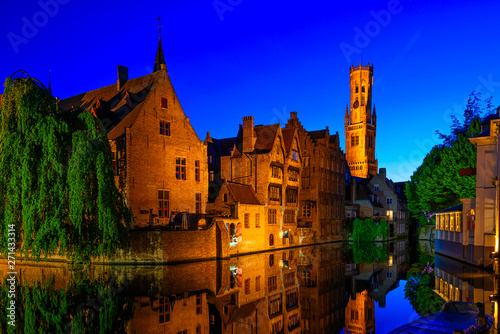 Classic view of the historic city center with canal in Brugge, West Flanders province, Belgium. Night cityscape of Brugge.