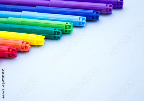 Colorful markers on a blue background. Multicolored markers with space for text.