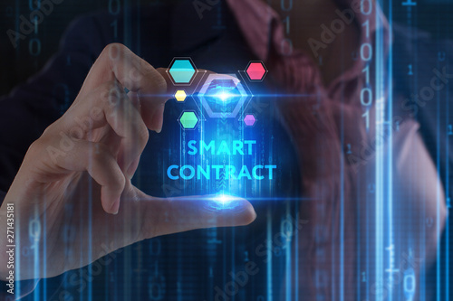 The concept of business, technology, the Internet and the network. A young entrepreneur working on a virtual screen of the future and sees the inscription: Smart contract