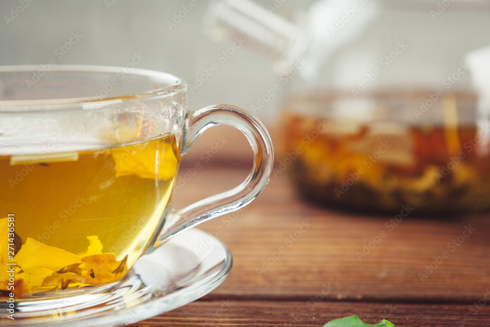 glass teapot with cup of black tea on wooden table glass teapot with cup of black tea on wooden table