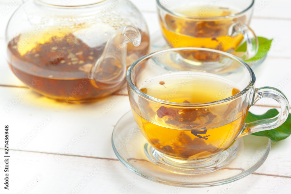 teapot and cups of tea on a white wooden background teapot and cups of tea on a white wooden background