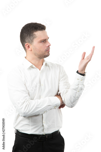 friendly young man pointing to his side and looking into the camera. isolated on white background